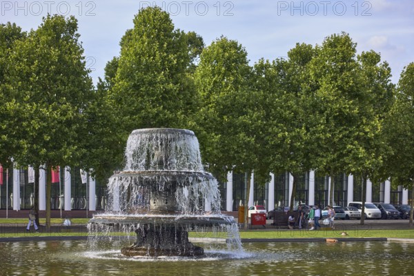 Cascade fountain, lawn, trees, general buildings, pedestrians as accessories, frozen movement,