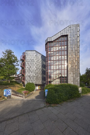 Theatre car park, modern architecture, entrance, access, sidewalk, trees, bushes, lawn, blue sky,