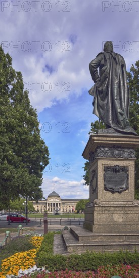 Kaiser Friedrich memorial, spa hotel, flower bed, trees, road, car, blue sky, cumulus clouds,