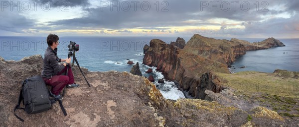 Photographer taking pictures on cliffs, volcanic peninsula, Ponta de São Lourenço, Ponta de Sao