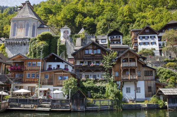 A, Hallstatt, central European village with old wooden houses on the water, surrounded by nature,