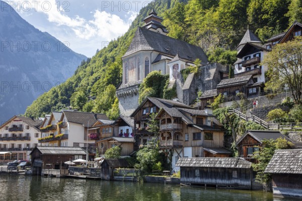 A, Hallstatt, picturesque village with characteristic wooden houses on the lakeside in front of a