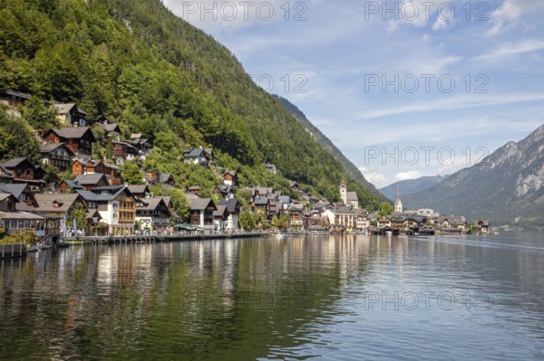 A, Hallstatt, panorama of a picturesque lakeside village with mountains in the background and a