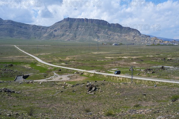 Panoramic view of a rural road winding through a vast mountain landscape, landscape near Demirtepe,