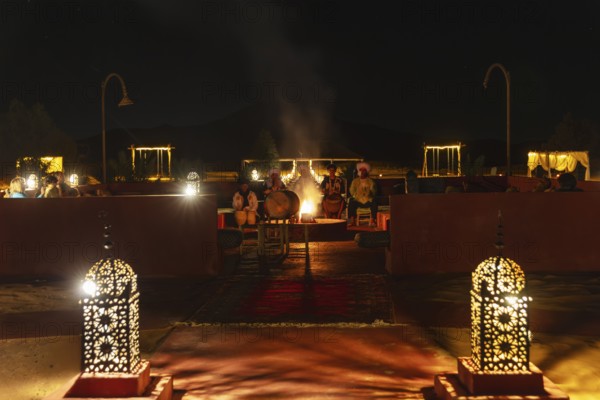 Evening meeting with lanterns and fireplace, cozy atmosphere, Sahara, Morocco