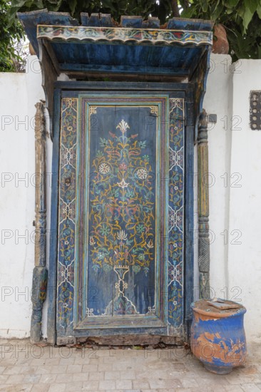 Elaborately decorated blue door with oriental patterns, the oldest door in the Kasbah of Oudaia in