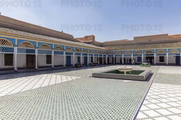 Spacious courtyard with central fountain and colorful arcades in the shadow of the sky, Bahia