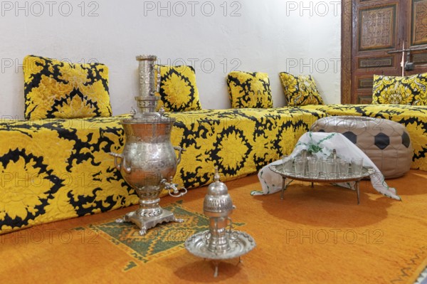 Inviting Moroccan sitting area with elaborate tea set on a decorative tray, Bahia Palace in