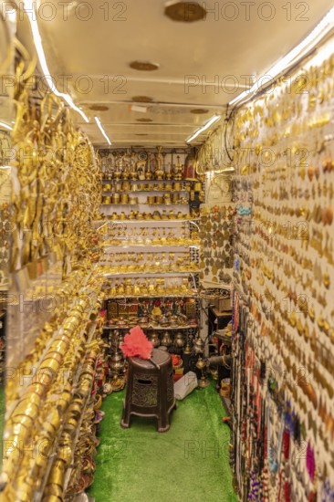 Tight shop full of shiny golden decorations and traditional goods