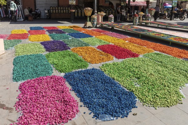 Colourful flower petals in creative patterns on an outdoor marketplace