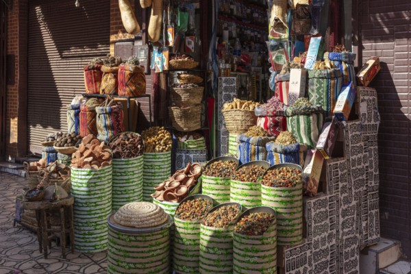 A colorful spice market in Marrakesh with bags and baskets full of fragrant spices and bright