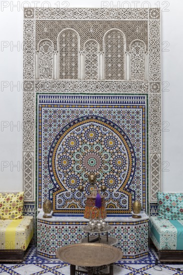 Richly decorated wall decoration with mosaics and traditional seating furniture