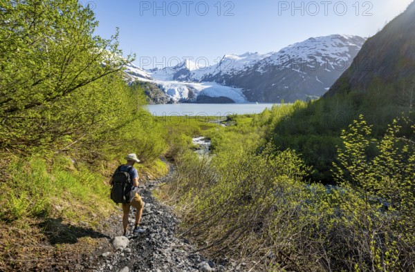 Hikers on the Portage Pass Trail, snowy mountains, Portage Glacier and Portage Lake, near Whittier,