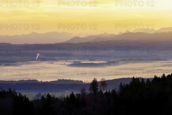 View from Horben of the Reuss Valley covered in fog, behind it the Glarus Alps in the light of the