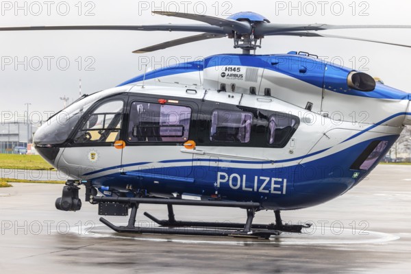 Helicopter from the Baden-Württemberg Police team in front of the hangar at the airport. Airbus