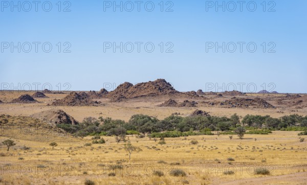 Desert landscape, barren landscape with hills of stacked rocks, Ugab River riverbed, Brandberg,