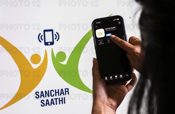 In this photo illustration, a person downloads the Sanchar Saathi mobile application on an iPhone,