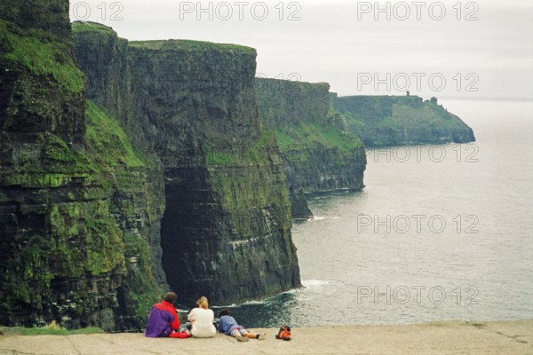 Young family, child, on the edge of a cliff, there was no fence back then, Cliffs of Moher, County