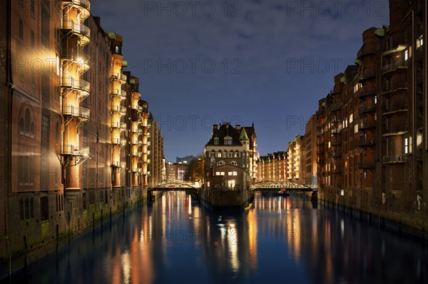 Night view, historic moated castle, warehouses, brick buildings, canal, Hamburger Speicherstadt,