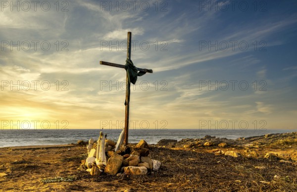 Religious scene, temporary Christian cross on the coast Farol de Cabo Raso lighthouse, São Bras de