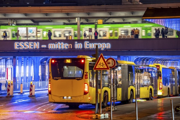 The main train station in Essen, blue illuminated underpass, bus station, am Europaplatz, train on