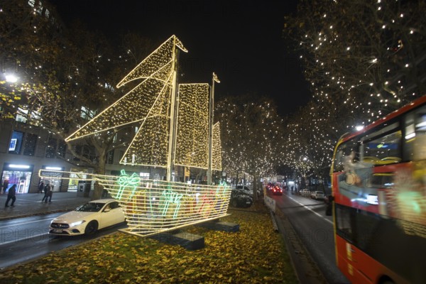 The Kurfürstendamm in western Berlin with Christmas lights and several light installations, such as