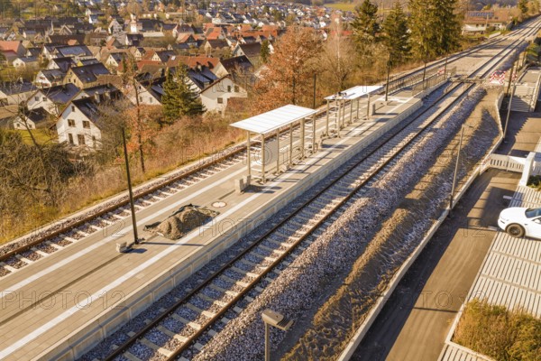 Aerial view of a rural train station with platform roof and tracks in the village, new Hermann