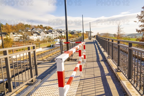 Footbridge with barrier in a modern environment, new Hermann Hessebahn railway station, Ostelsheim,
