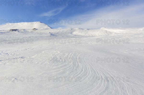 Desolate windswept snow covered Arctic landscape at Mohnbukta, bay at the western shore of