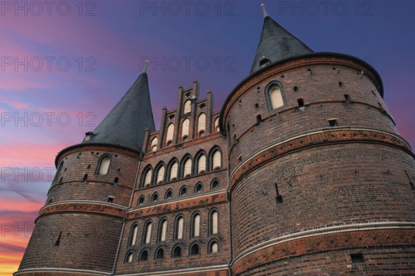 Holstentor, historic city gate from 1478, evening sky, Holstentorplatz, Hanseatic City of Lübeck,