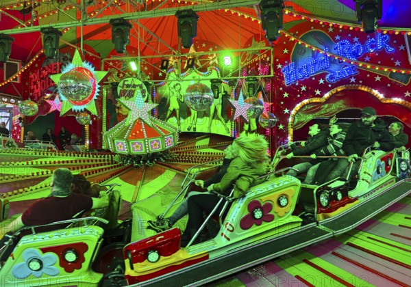 People on the Musik-Express ride at the All Saints Fair, the biggest old town fair in Europe,