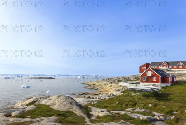 Typical architecture of Greenland Ilulissat with colored houses located near fjords and icebergs
