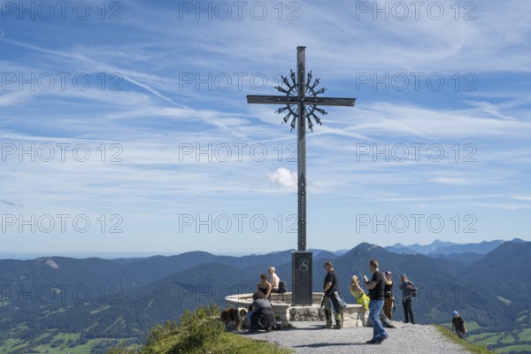 Summit cross with tourists, Brauneck 1555m, Bavarian Prealps, Isarwinkel, Lenggries, Upper Bavaria,