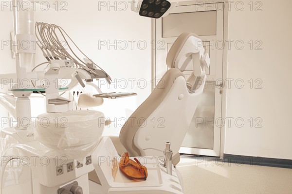 Modern dental clinic interior with equipment and patient chair ready for treatment