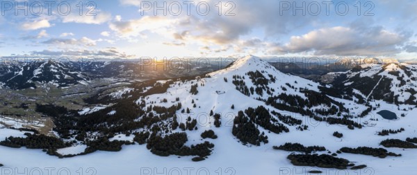 Sunset, alpine panorama, fantastic winter landscape with Hohe Salve, blue sky and snow, mountains