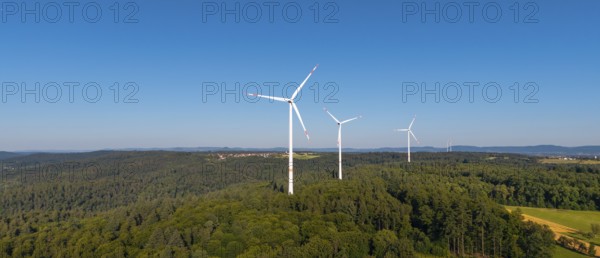 Wind turbines in a green hilly landscape, standing in a clear sky, near Schorndorf, Remstal,