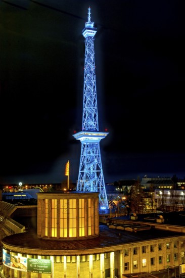 Blue-lit Berlin radio tower, steel half-timbered building by architect Heinrich Straumer, Langer