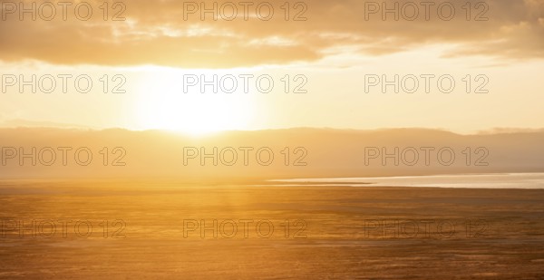 View of savanna landscape at sunrise, atmospheric morning light, view of Ngorongoro Crater, back