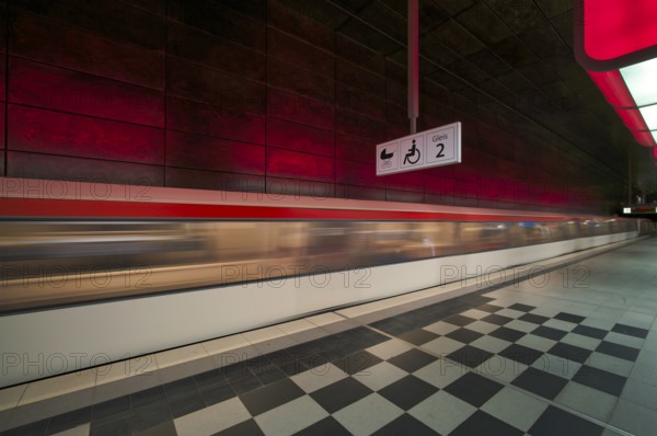 HafenCity University underground station, illuminated in color, red, underground train, movement