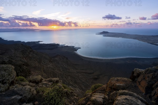 View from steep cliffs to sea and coast with sun stars, Mirador del Porrito viewpoint at sunset,