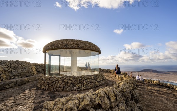 Staircase and viewing platform at the Mirador del Río viewpoint, in the evening light with sun