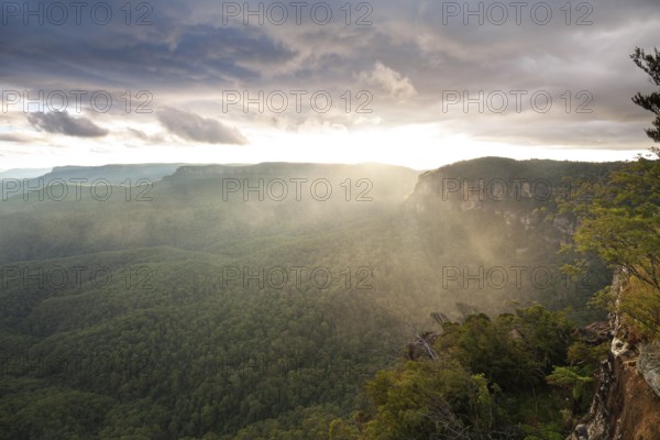 Evening sky with clouds of fog and setting sun at the Three Sisters at Echo Point in Katoomba, Blue