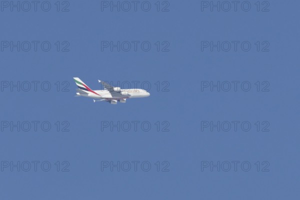 Airbus A380 jet passenger aircraft of Emirates airlines flying in a blue sky, England, United