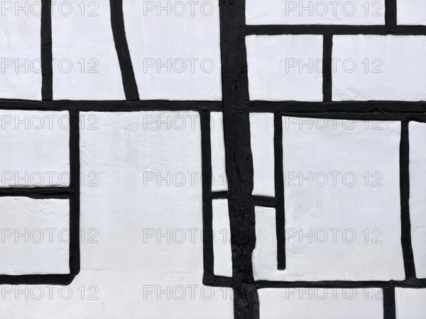 Unusual framework of irregularly arranged rectangular wooden beams in three compartments,