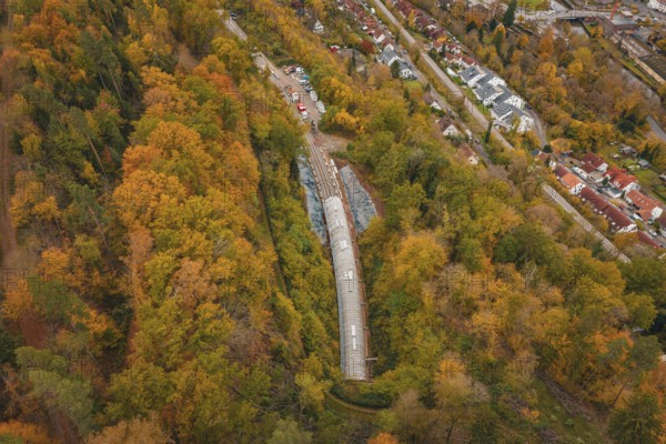 City panorama with view of a train tunnel in an autumnal forest, Hermann-Hesse-Bahn construction