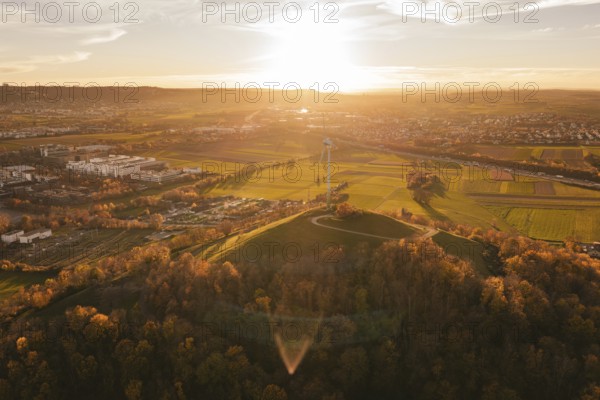 Extensive panorama with fields, forest and a wind turbine in the evening light, Grüner Heiner,