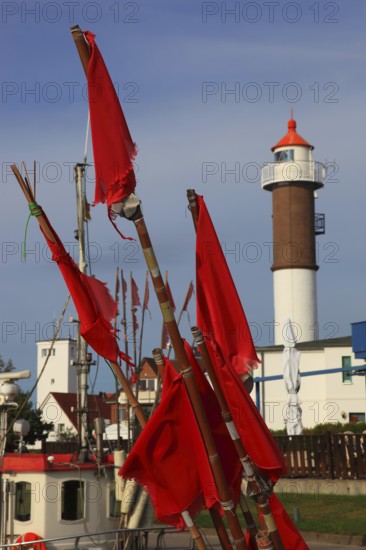 Timmendorf lighthouse on the island of Poel on the Baltic Sea, rigging and flags from a boat in the