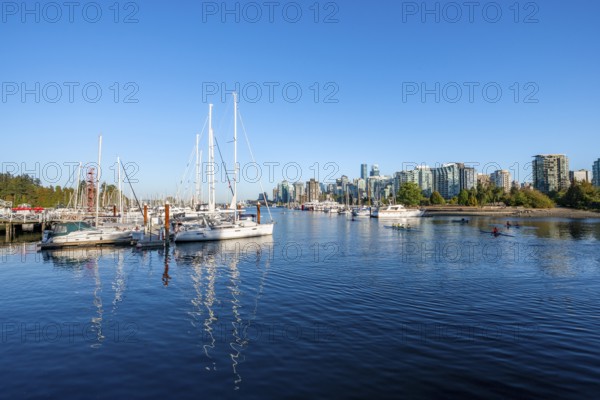 Skyscrapers and sailboats in the marina, Vancouver skyline reflected in the ocean, Coal Harbour,