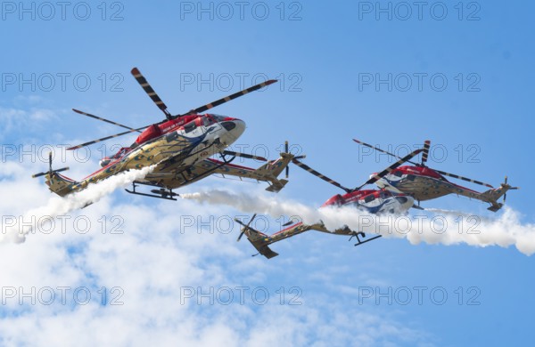 Indian Air Force (IAF) ALH Mk1 Sarang helicopters soar through the sky during an air show as part
