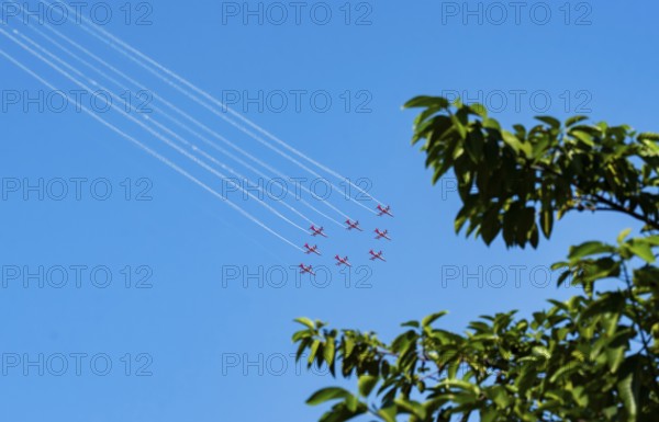 The Indian Air Force (IAF) Surya Kiran aerobatics team performs during an air show as part of the